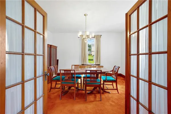 a view of a dining room with furniture window and hardwood floor