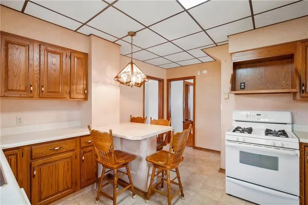 a kitchen with a stove a sink and cabinets
