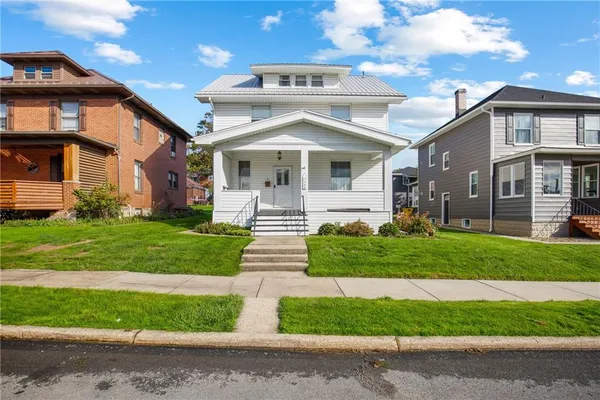 a front view of a house with a yard