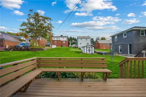 a front view of a house with a yard and entertaining space