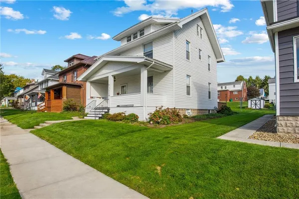 a front view of house with yard and green space