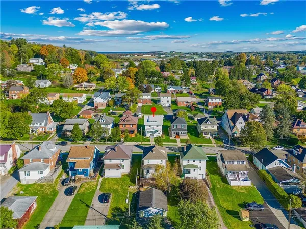 an aerial view of residential houses with outdoor space and street view