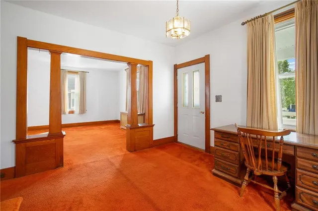 wooden floor and windows in a room with a chandelier