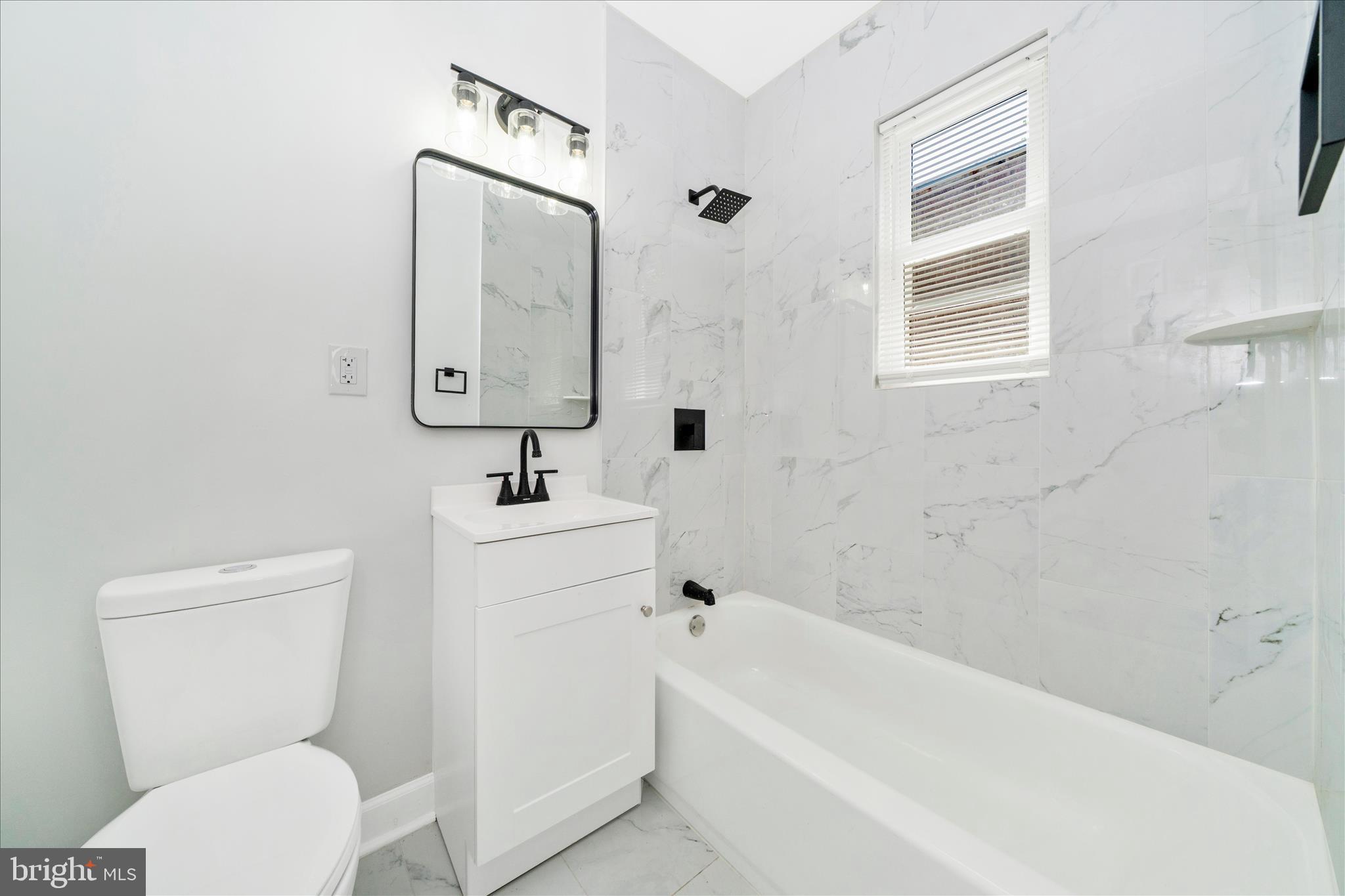 5027 Benning Road Southeast Washington, DC 20019 - Photo 42 of 57 a bathroom with a toilet a sink and bathtub