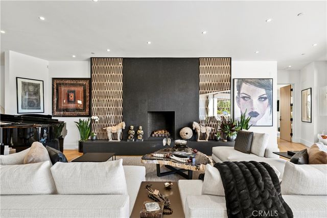 a living room with furniture window and a fireplace