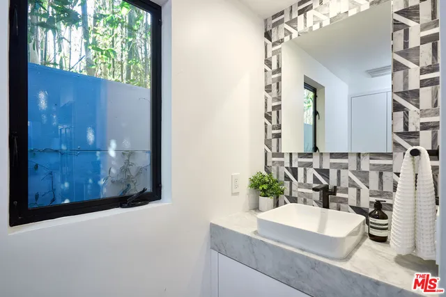 a bathroom with a sink and a mirror