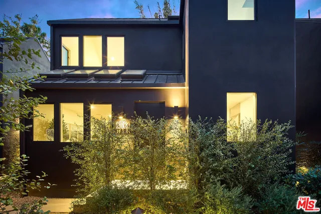 a bathroom with a granite countertop sink and a window