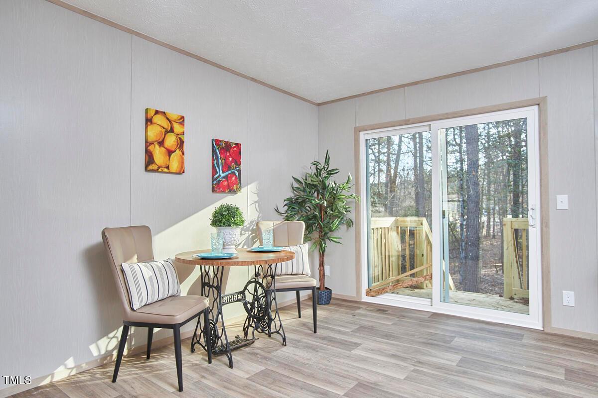 48 Bone Oak Sanford, NC 27332 - Photo 12 of 21 a view of a dining room with furniture a chandelier and wooden floor