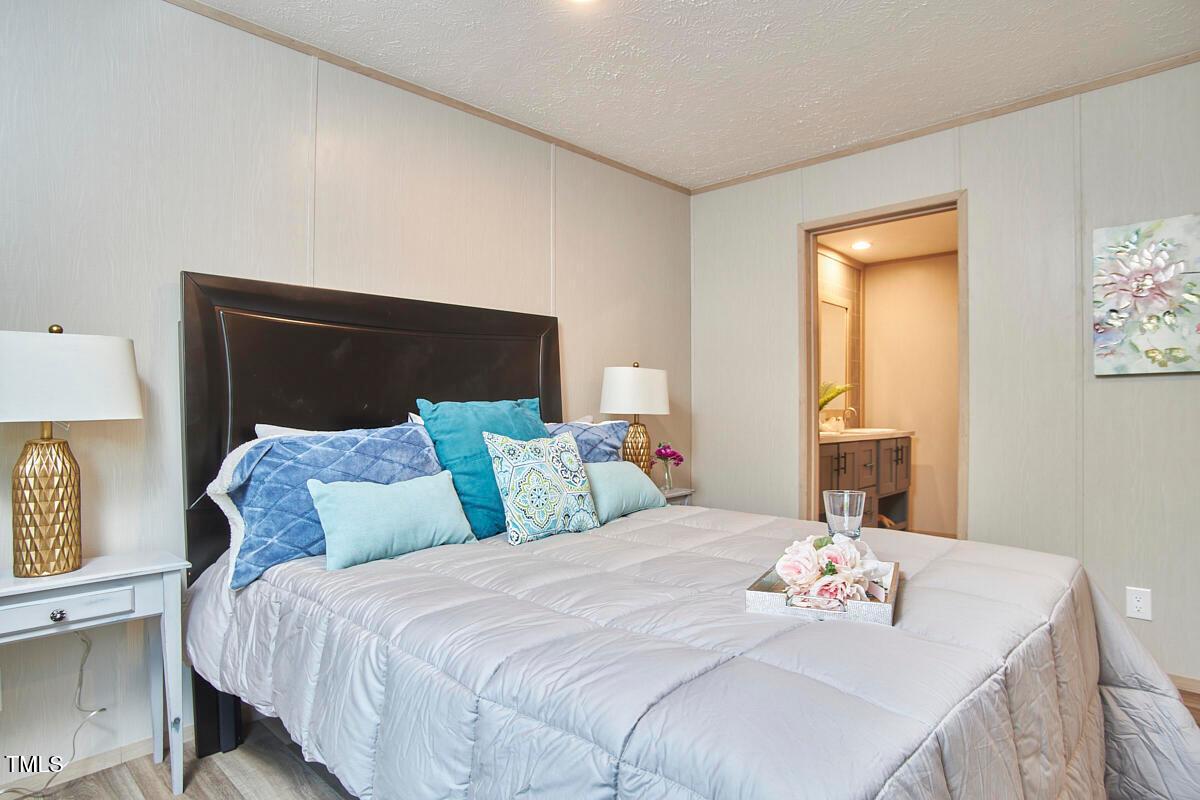 48 Bone Oak Sanford, NC 27332 - Photo 14 of 21 a bedroom with a bed and wooden floor