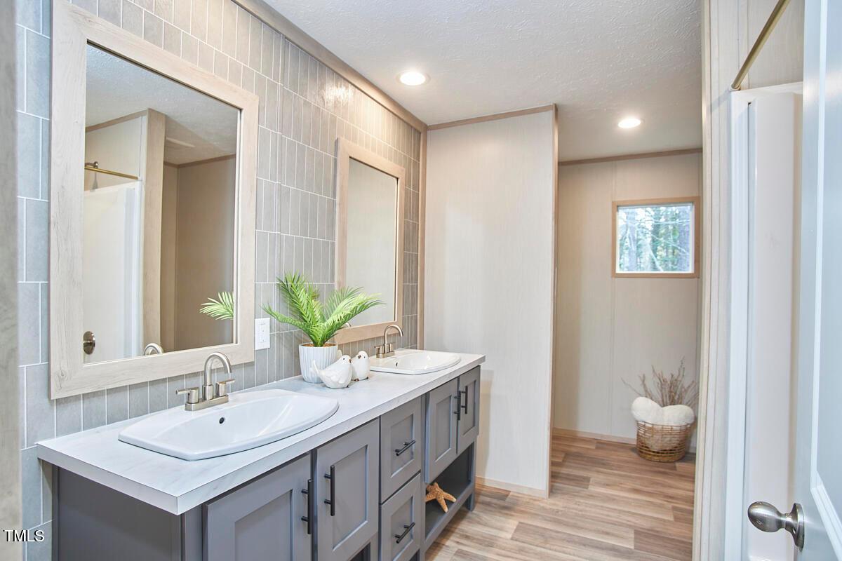 48 Bone Oak Sanford, NC 27332 - Photo 15 of 21 a bathroom with a double vanity sink and a mirror