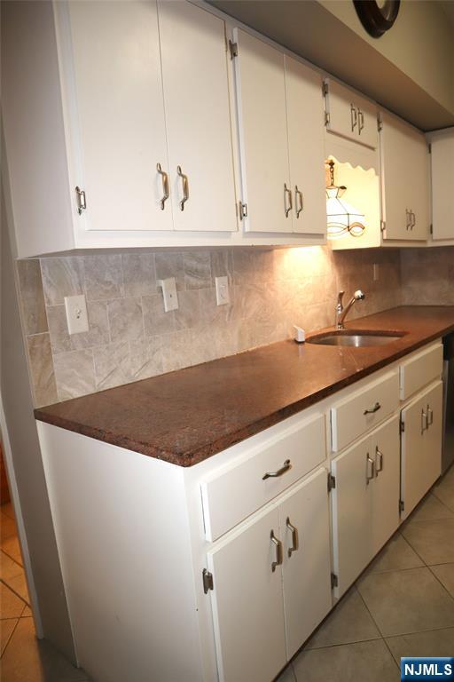 97 Squaw Brook Road North Haledon, NJ 07508 - Photo 15 of 19 a kitchen with granite countertop white cabinets and white appliances