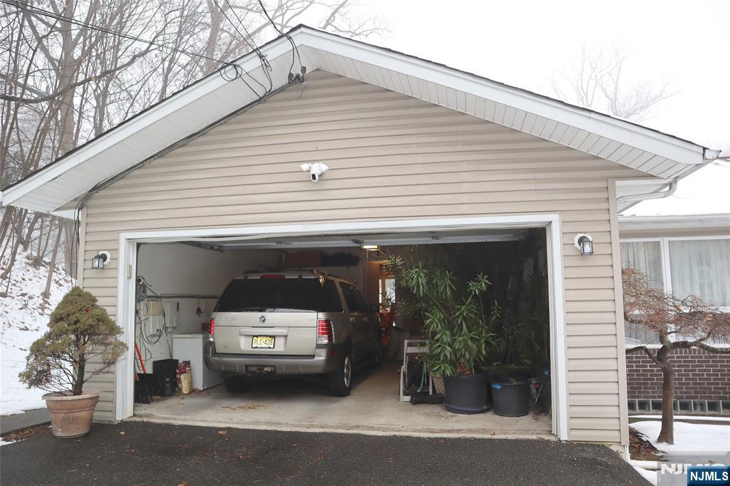 97 Squaw Brook Road North Haledon, NJ 07508 - Photo 19 of 19 a car parked in front of a white house