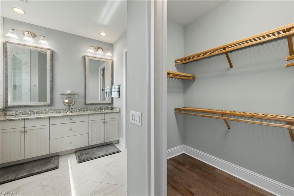 6420 Pembroke Way Naples, FL 34113 - Photo 15 of 39 Master Bathroom with dual sink vanity, 2 walk-in closets
