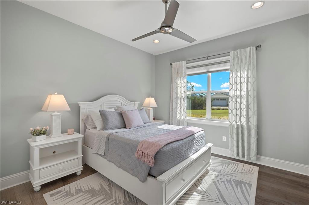 6420 Pembroke Way Naples, FL 34113 - Photo 18 of 39 Bedroom 2 of 3 featuring wood-flooring and ceiling fan