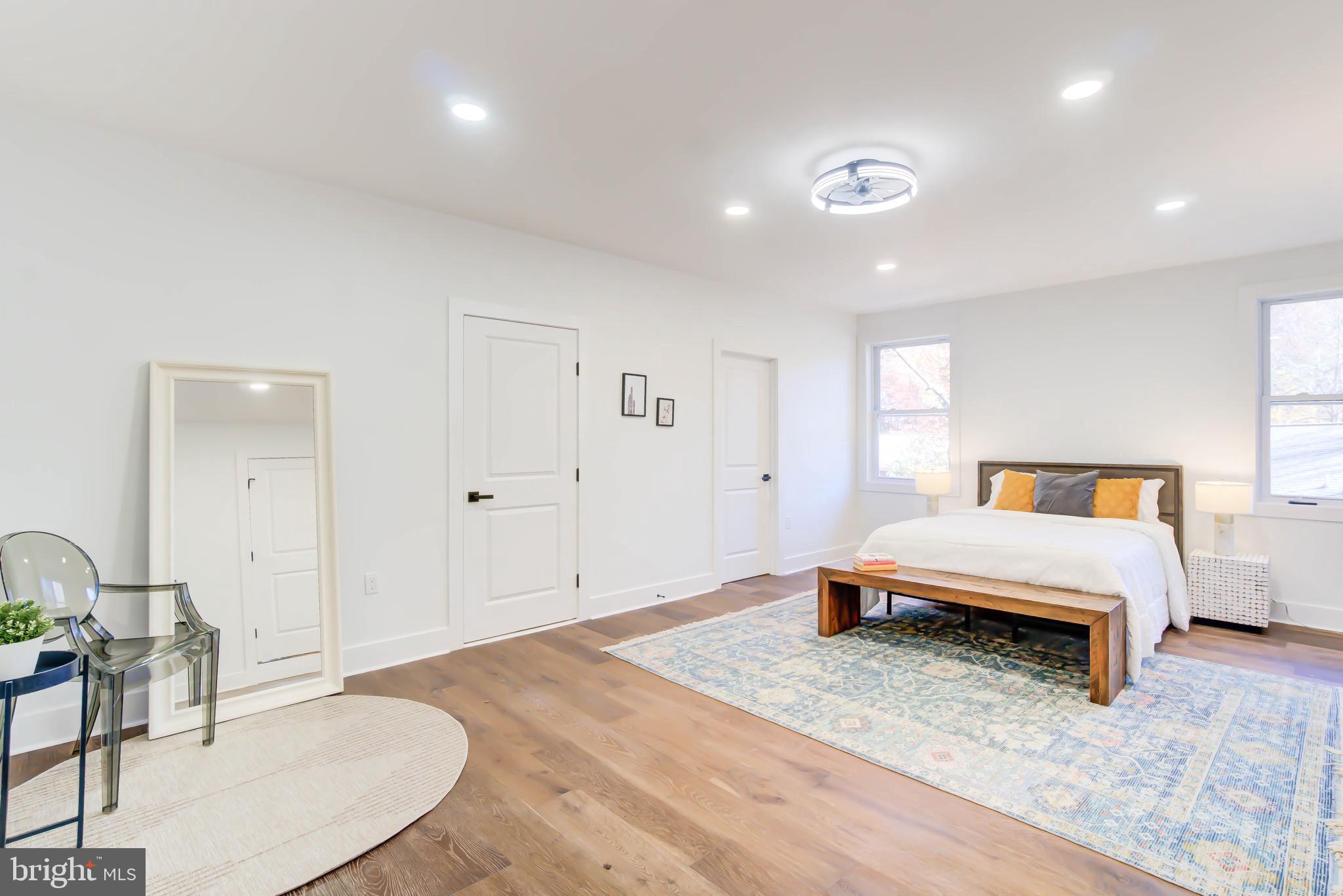 1206 La Grande Road Silver Spring, MD 20903 - Photo 14 of 45 a spacious bedroom with a bed a table and chair