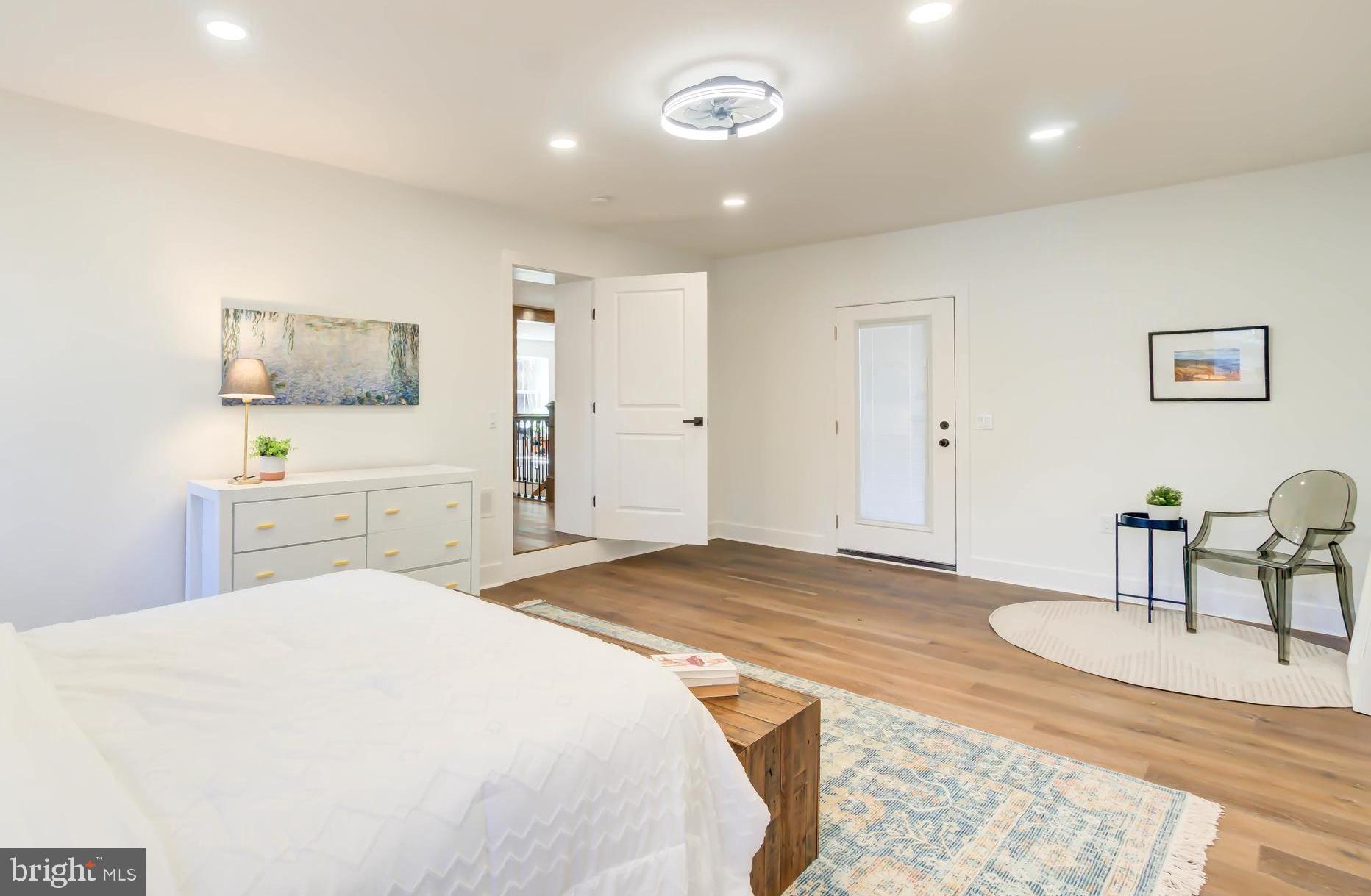 1206 La Grande Road Silver Spring, MD 20903 - Photo 17 of 45 a spacious bedroom with a bed and a furniture