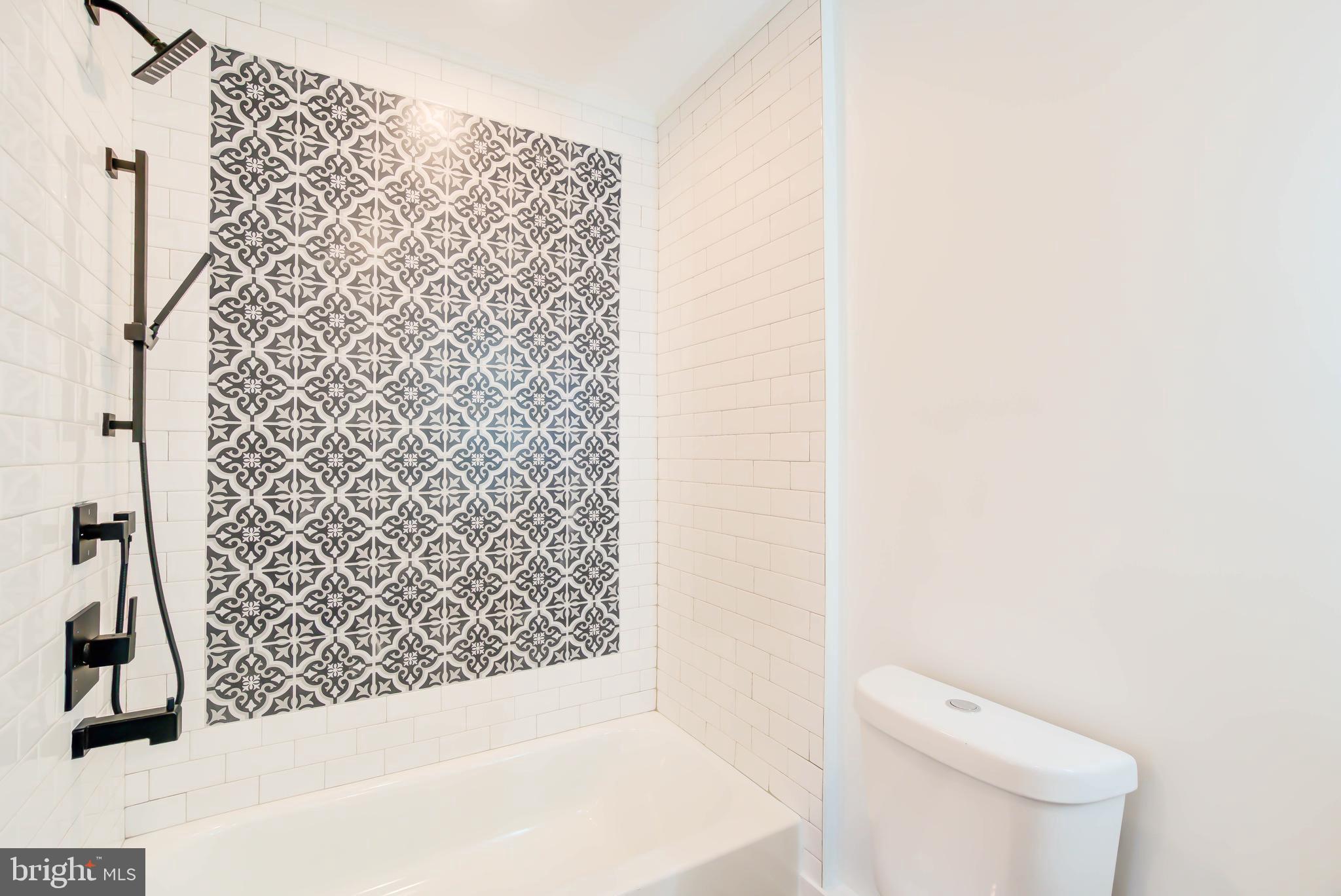 1206 La Grande Road Silver Spring, MD 20903 - Photo 24 of 45 a bathroom with a toilet and a shower curtain