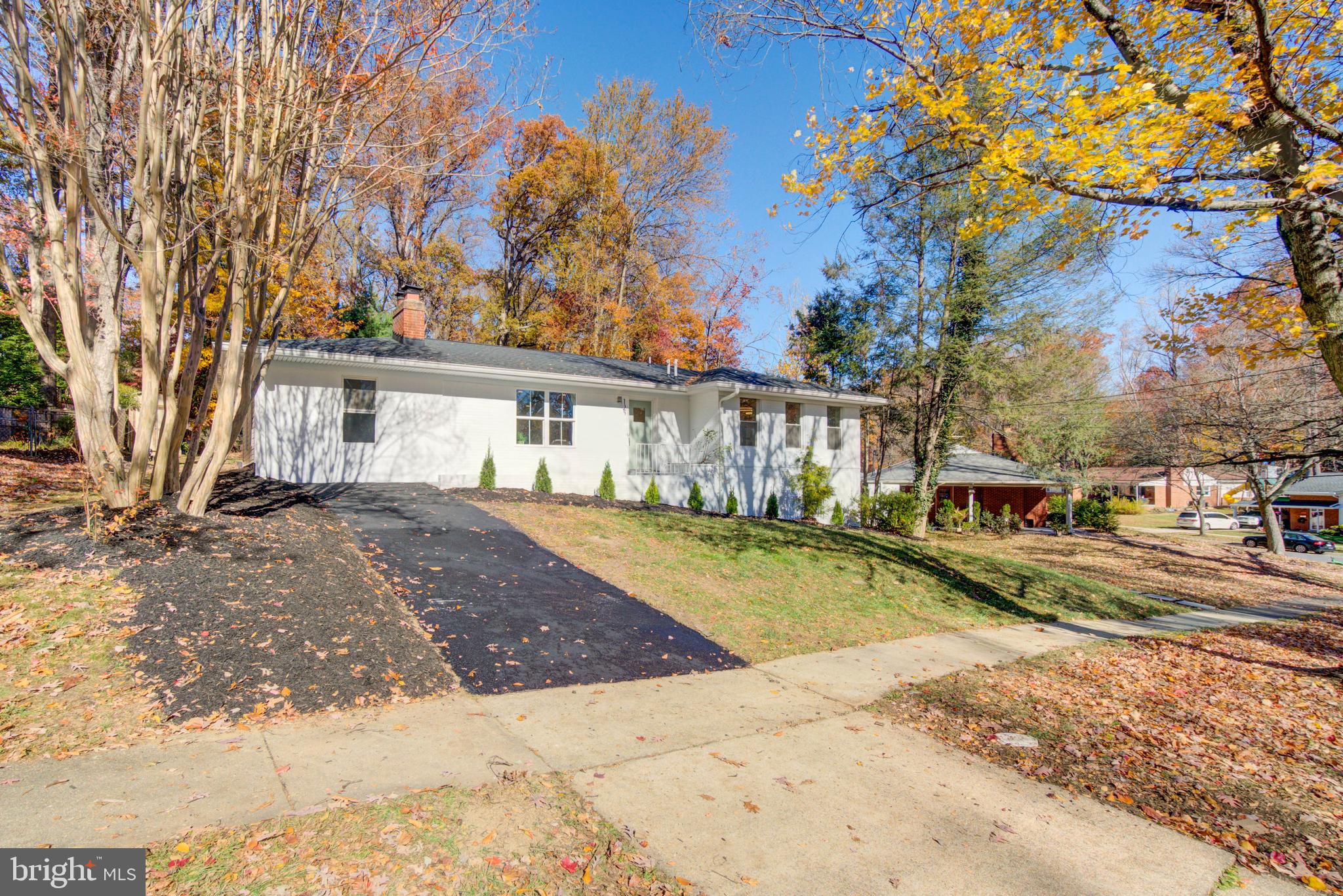 1206 La Grande Road Silver Spring, MD 20903 - Photo 43 of 45 a view of a white house with a large trees with wooden fence