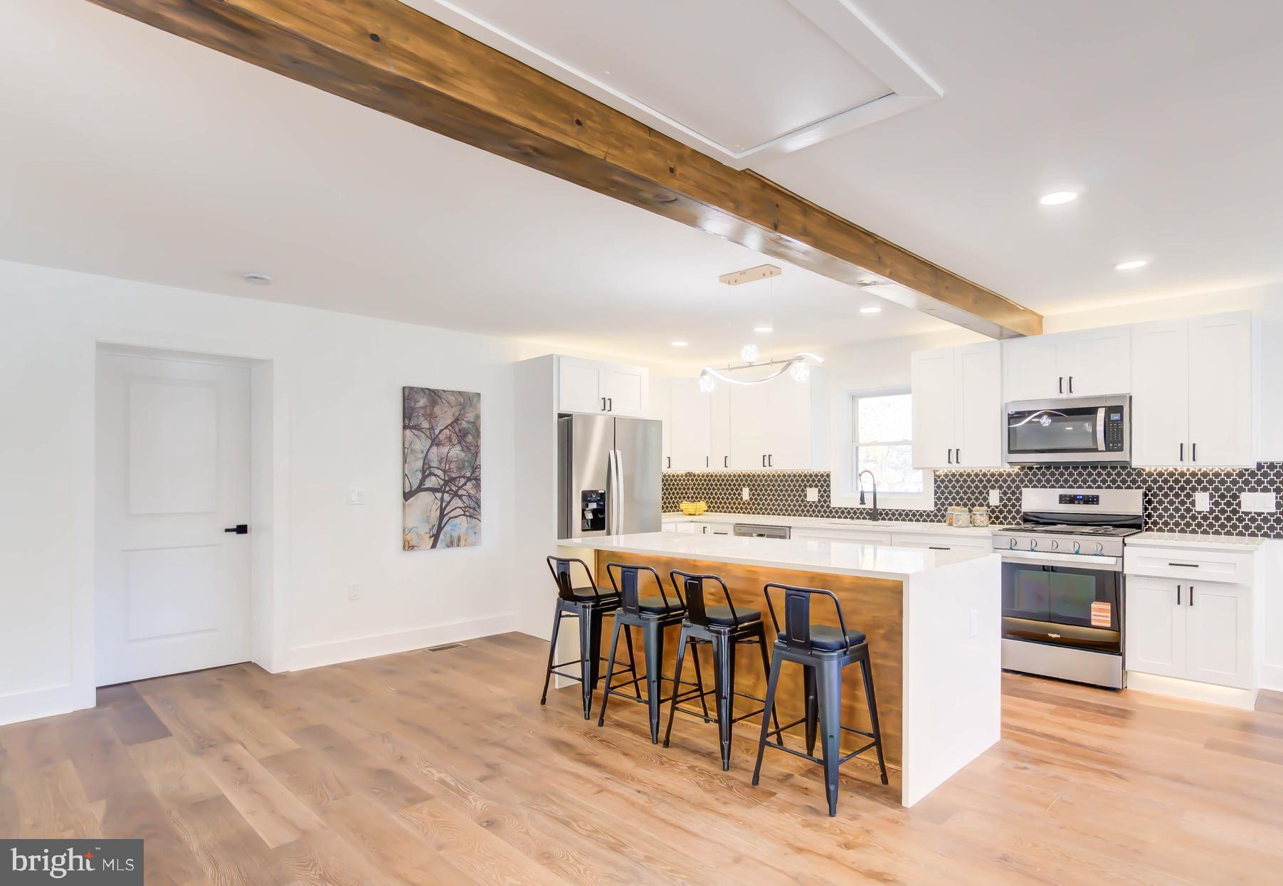1206 La Grande Road Silver Spring, MD 20903 - Photo 6 of 45 a open kitchen with stainless steel appliances granite countertop a stove and a refrigerator