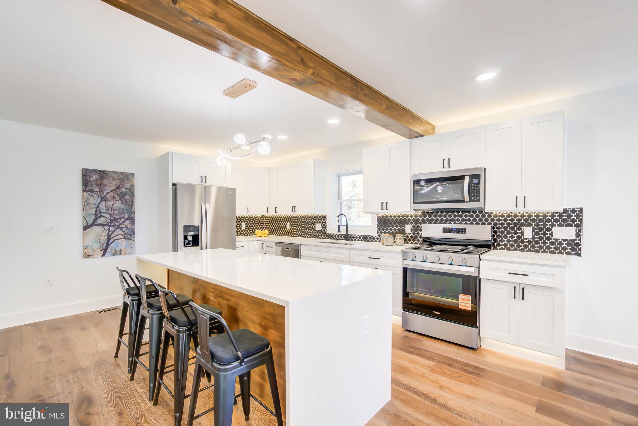 1206 La Grande Road Silver Spring, MD 20903 - Photo 7 of 45 a kitchen with stainless steel appliances a stove a sink dishwasher and a refrigerator