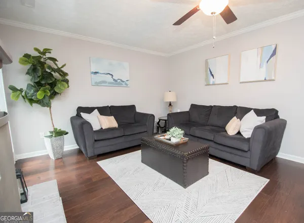 a living room with furniture and a potted plant