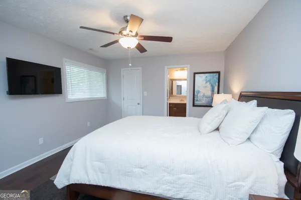 a bedroom with a bed and a flat screen tv