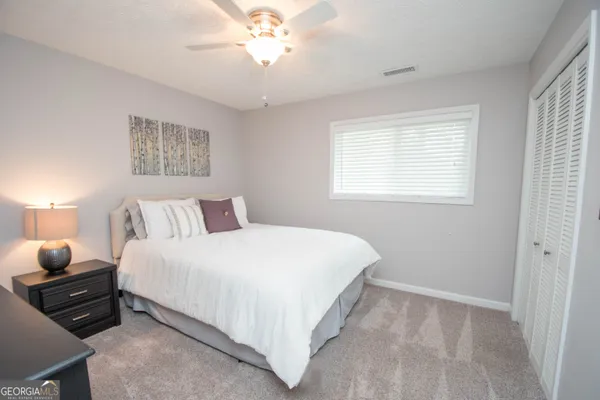 a bedroom with bed and window