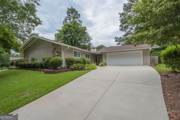 a front view of a house with garden
