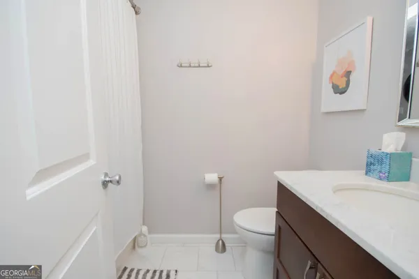 a bathroom with a sink a toilet and vanity