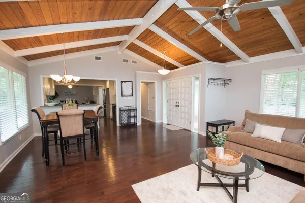 a dining room with furniture window and wooden floor