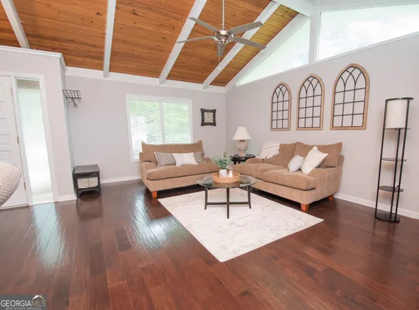 a living room with furniture and wooden floor
