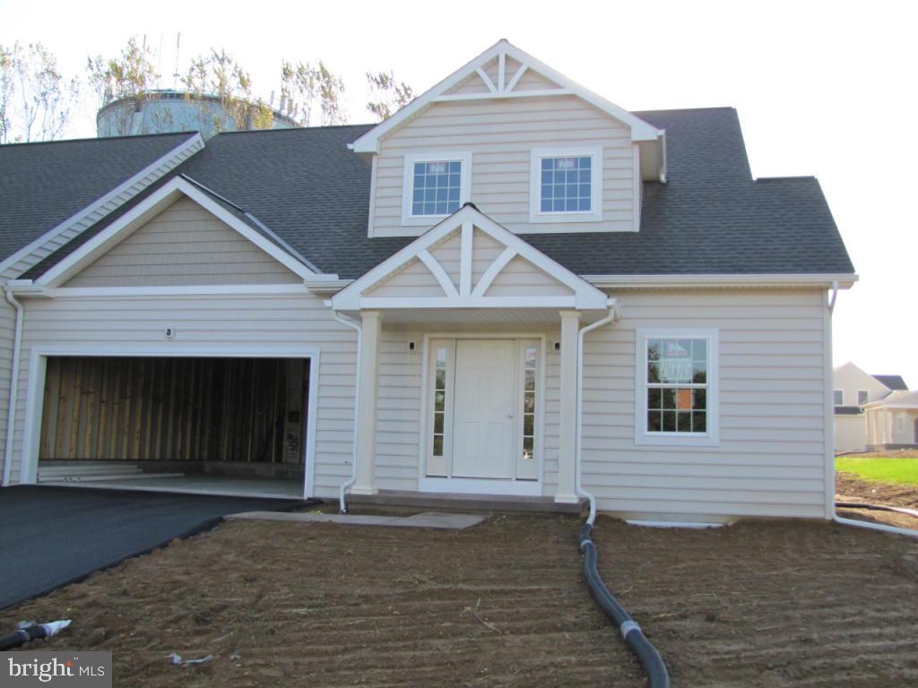139 Baneberry Lane, Unit 15 Lititz, PA 17543 - Photo 1 of 9 a front view of a house with a yard and garage