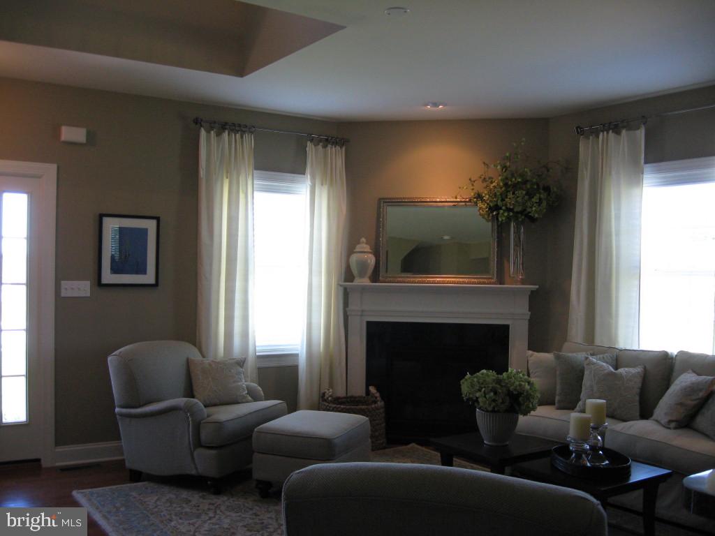 139 Baneberry Lane, Unit 15 Lititz, PA 17543 - Photo 2 of 9 a living room with furniture and a fireplace