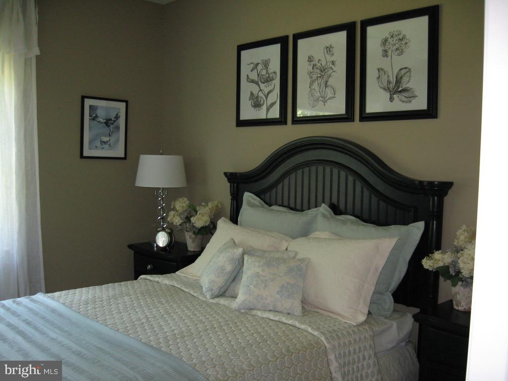 139 Baneberry Lane, Unit 15 Lititz, PA 17543 - Photo 8 of 9 a bedroom with a bed and a painting on the wall