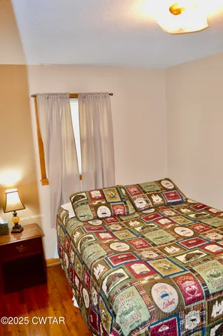 a bedroom with a bed and a lamp