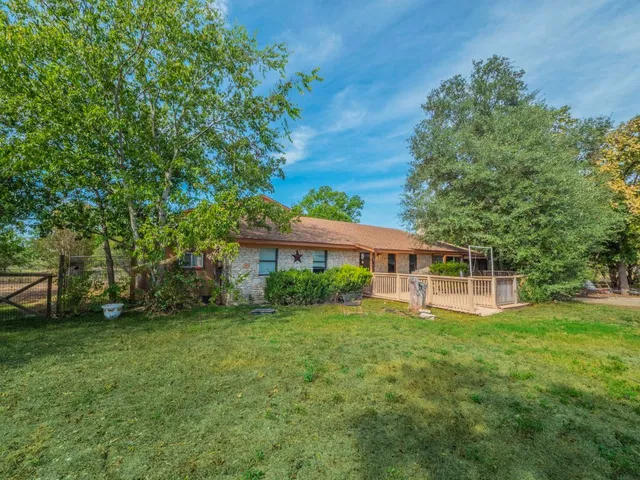 a view of a house with a yard and sitting area