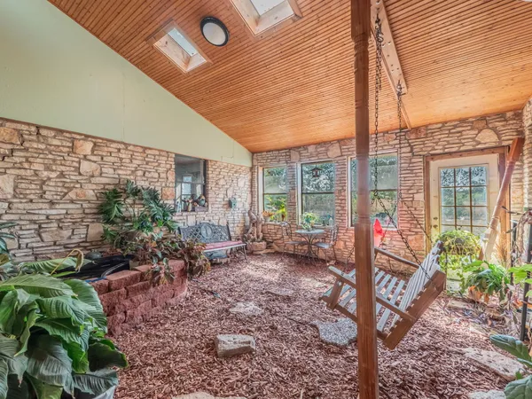 a view of a backyard with garden and patio