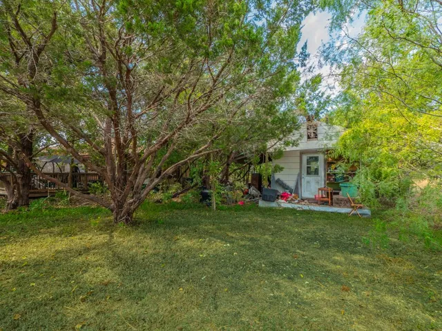 a view of a house with a yard and sitting area