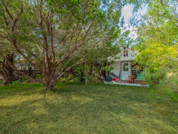 a view of a house with a yard and sitting area