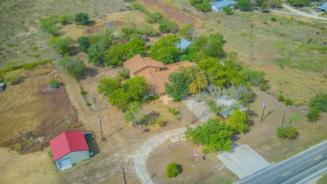 an aerial view of a house with a yard