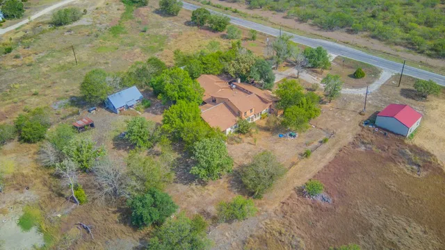 an aerial view of a house with a yard