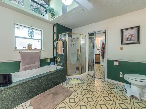 a spacious bathroom with a sink a toilet and shower