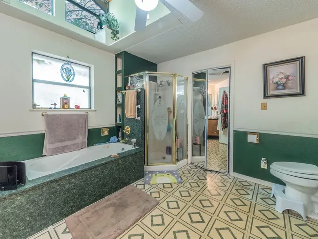 a spacious bathroom with a sink a toilet and shower