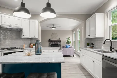 a kitchen with stainless steel appliances granite countertop a sink dishwasher stove and cabinets