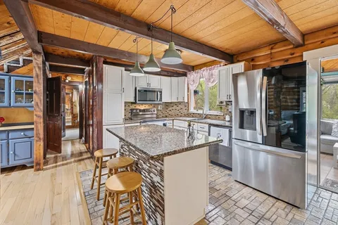 a kitchen with stainless steel appliances granite countertop a sink and cabinets