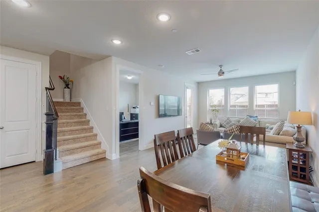 a dining room with furniture and wooden floor