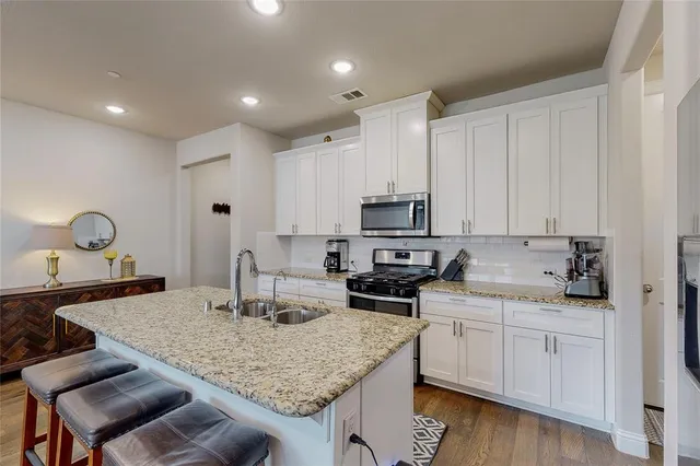 a kitchen with sink cabinets and stove