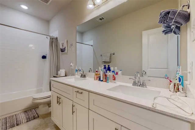 a bathroom with a sink double vanity and toilet