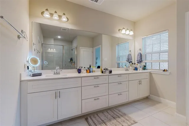 a bathroom with double sink and a mirror