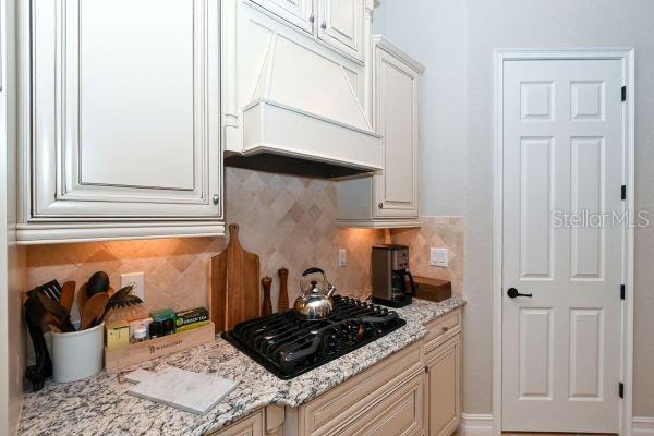5507 Arnie Loop Lakewood Ranch, FL 34211 - Photo 12 of 68 a kitchen with a stove and a refrigerator